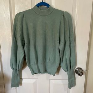 Turquoise turtle neck sweater with puff sleeves.